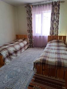 a bedroom with two beds and a window at Ысык-Кол Чок-Тал in Chok-Tal