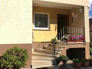 una casa con escaleras y flores en una ventana en Apartment Gosberg - 90qm, en Pinzberg