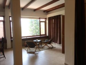 a living room with chairs and a table and a window at Miriam Short Term Rental in Nazareth +58 photos