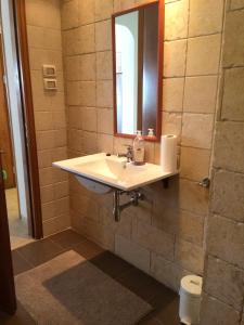 a bathroom with a sink and a mirror at Miriam Short Term Rental in Nazareth