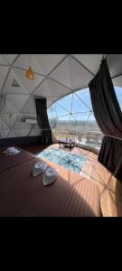 a large tent with a bed with two hats on it at View x Camping in Ban Non Na Yao