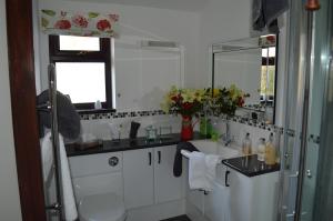a white bathroom with a sink and a mirror at Smithfield Farm Bed & Breakfast in Builth Wells +31 photos