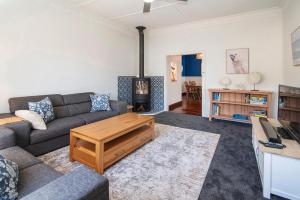 a living room with a couch and a coffee table at Seashells Beach house on Dorset in Busselton