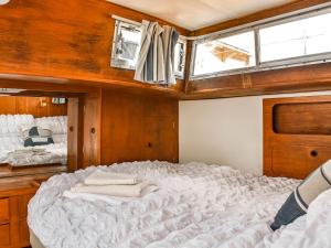 a large bed in the center of a boat at The Rose in Rhondda