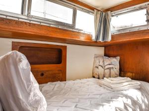 a bedroom with a bed in a boat at The Rose in Rhondda +7 photos