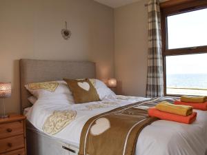 En eller flere senge i et værelse på Sea Breeze Cottage