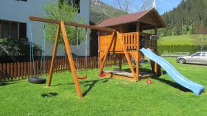 a playground with two swings and a gazebo at Large cozy apartment Grubweg 130 qm in Sankt Martin am Tennengebirge