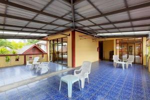 a large patio with white chairs and a table at Island View Bungalows in Choeng Mon Beach