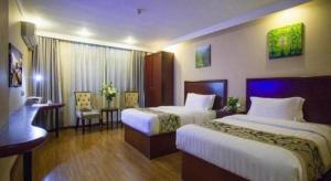 Ένα ή περισσότερα κρεβάτια σε δωμάτιο στο GreenTree Inn Taizhou Gaogang District Business Hotel