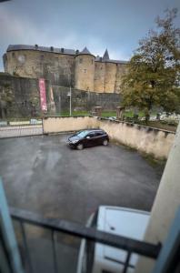 a car parked in a parking lot in front of a castle at Appartement Sedan in Sedan +8 photos