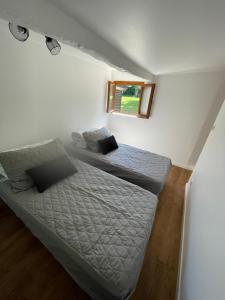 a bedroom with a bed and a window in it at Maison à la campagne in Auvilliers