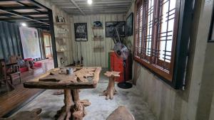 a room with a table and a fan and windows at Harmony Hideaway Villa-Seeduwa in Seeduwa