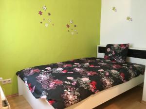 a bedroom with a bed with flowers on the wall at 25 Bollendorf in Bollendorf-Pont