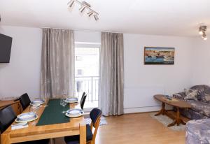 a dining room with a table and a couch at Apartments Kastilac near the beach in Kaštela