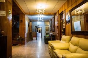 a living room with a couch and a chandelier at Kaaro Hotel Suite in Puno