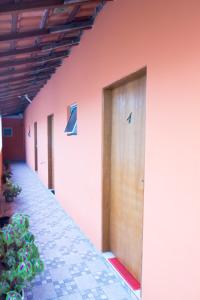 a row of doors on the side of a building at Boituhostel in Boituva