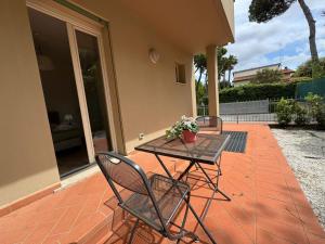 a table and two chairs on a patio at Residence San Francesco in Tirrenia