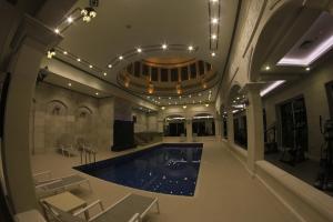 a large room with a pool in a building at Adams Hotel in Kuwait