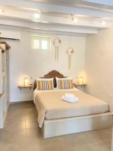 a bedroom with a large bed with two lamps at ALEMINAS House 1 in Symi