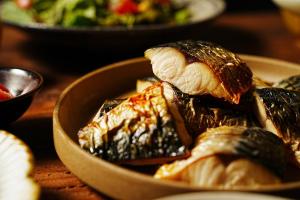 a bowl of food on a table with food at Toyo Hotel in Fukuoka
