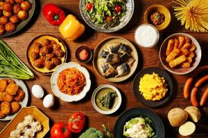 a wooden table with plates of food on it at Toyo Hotel in Fukuoka