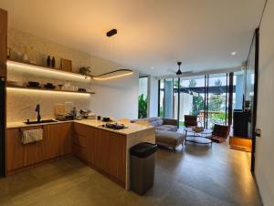 a kitchen and living room with a couch and a table at Villa Anvaya in Pasuruan