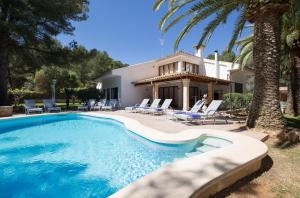 a villa with a swimming pool in front of a house at Cabot Villa Can Borras in Port de Pollensa