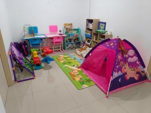 a room with a pink tent in a classroom at 10-14Pax Port Dickson 4BR Rara homestay in Port Dickson