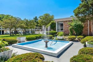 a fountain in the middle of a garden at Howard Johnson by Wyndham Albany in Albany