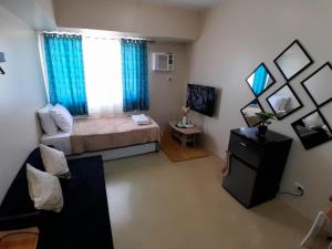 a small bedroom with a bed and a window at The Suite Pod I CDO CondoStaycation - U23 in Cagayan de Oro