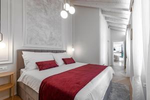 a bedroom with a large bed with a red blanket at Luxury villa Lia in Dubrovnik