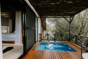 a house with a swimming pool on a deck at Rhino Plains in Welgevonden Game Reserve