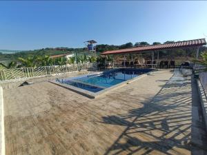 a large swimming pool with a pavilion next to it at Nana's Farm and Resort in Jāmb