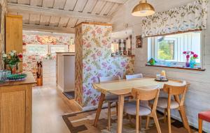 a kitchen and dining room with a wooden table and chairs at Amazing Home In Höviksnäs With Wifi in Höviksnäs