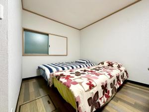 Uma cama ou camas num quarto em 西軽井沢小木屋