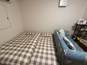 Uma cama ou camas num quarto em 西軽井沢小木屋