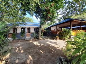 a house with a tree in front of it at Bunaken Sunrise Beach in Manado