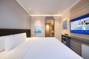 Ένα ή περισσότερα κρεβάτια σε δωμάτιο στο Hanting Youjia Beijing Guang An Men Grand View Garden Hotel