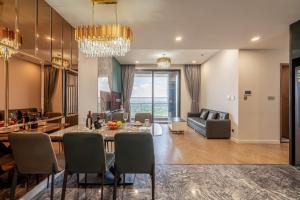 a living room and dining room with a table and chairs at The Luxury Lumiere Riverside Suite in Ho Chi Minh City +112 photos