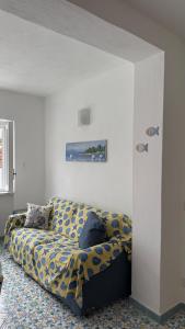 a living room with a couch in a room at Perla Bianca Holiday Home, Forio in Forio d'Ischia +20 photos