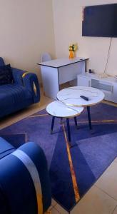 a living room with two tables and a couch at Blissful homes in Ruiru