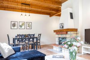 a living room with a blue couch and a fireplace at Bielawki Domek Kaszuby jezioro Gowidlińskie in Borek +25 photos