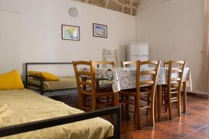 a dining room with a table and chairs and a bed at Terrasini 2000 Casa Vacanze in Terrasini +95 photos
