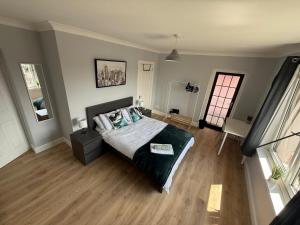 a bedroom with a bed and a large window at 3-Bed Flat in Musselburgh in Musselburgh