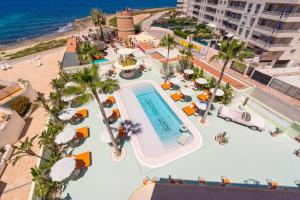 an overhead view of the pool at the beach at Grand Paradiso Ibiza - Adults Only in San Antonio Bay