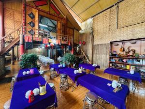 a room with blue tables and chairs in it at Homestay Hoa ban in Mộc Châu