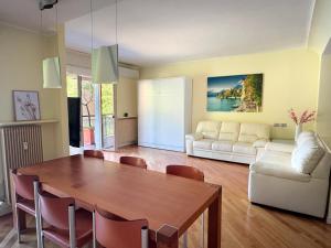 a living room with a table and a couch at Grand View Como Lake Apartment 3 in Abbadia Lariana