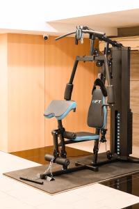 a gym with a chair in a room at Golden Empire Suvarnabhumi Hotel in Bang Kew Yai