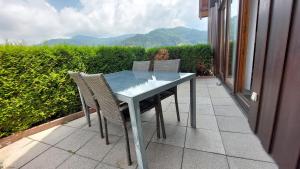 a table and chairs on a patio with a view at Ferienwohnungen Sonnenhalde mit schöner Aussicht in Forbach