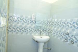 a bathroom with a sink and a toilet and a mirror at Hotel Moon -Near Bus Stand Panipat in Pānīpat +21 photos